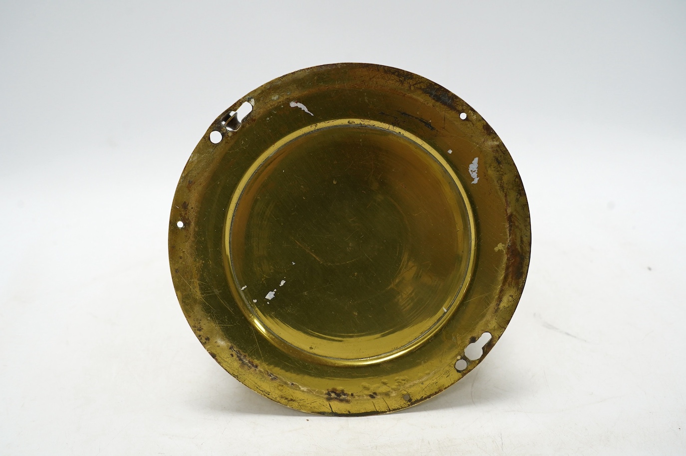 An early 20th century brass bulkhead timepiece retailed by Harrods, dial 13.5cm. Condition - poor to fair, seconds hand missing and some cracks to enamel dial